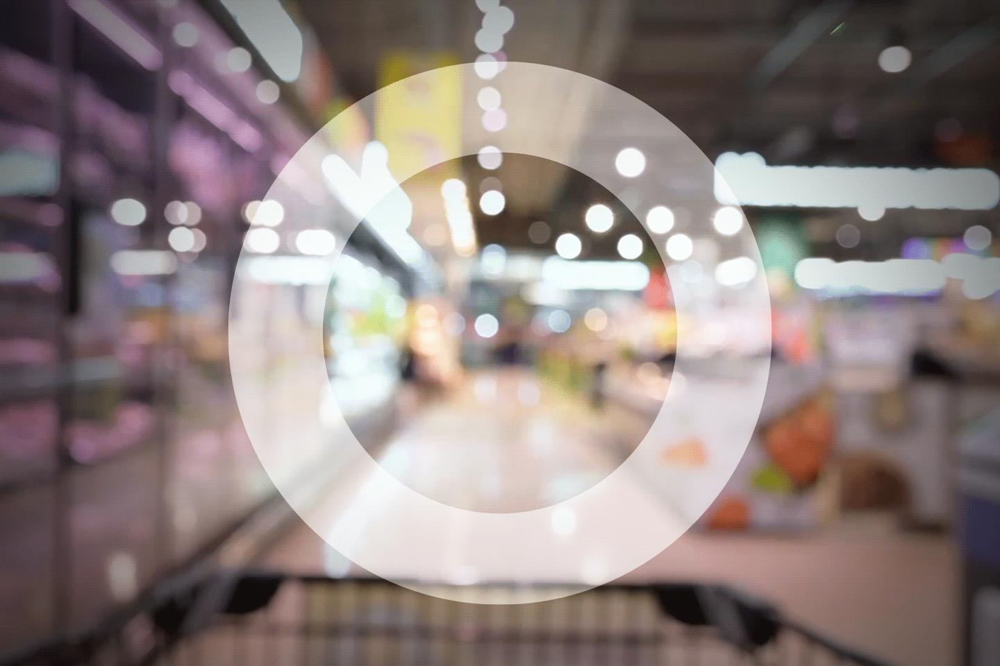 Trolley in supermarket aisle from the point of view of the shopper